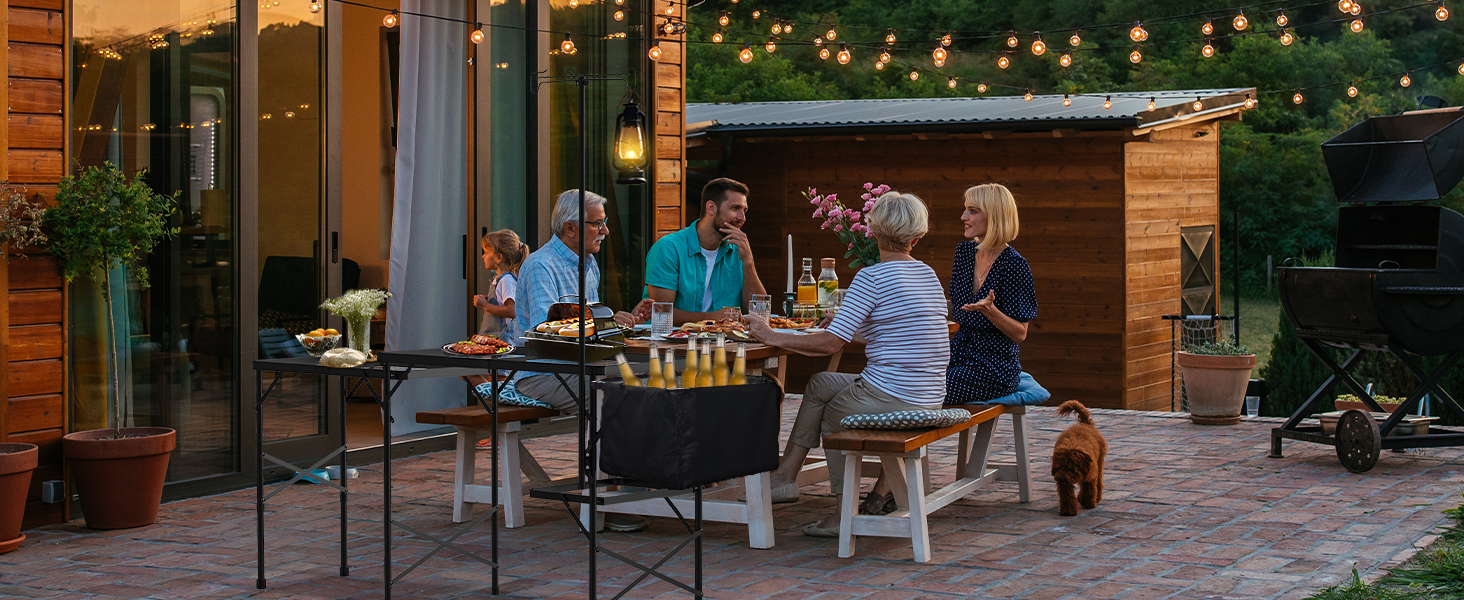 WildFinder cooking station at an evening dinner on a lit patio